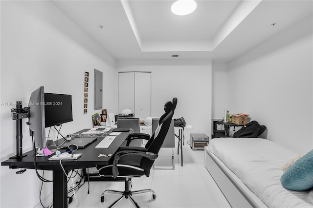 office area with a raised ceiling