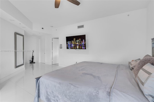 tiled bedroom featuring ceiling fan