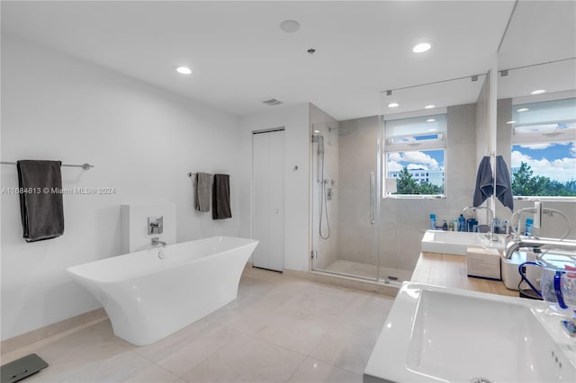 bathroom featuring vanity, tile patterned floors, and shower with separate bathtub