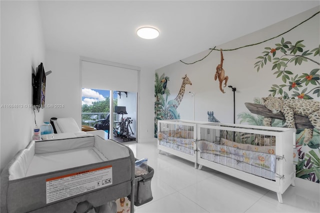 bedroom featuring light tile patterned flooring and access to exterior