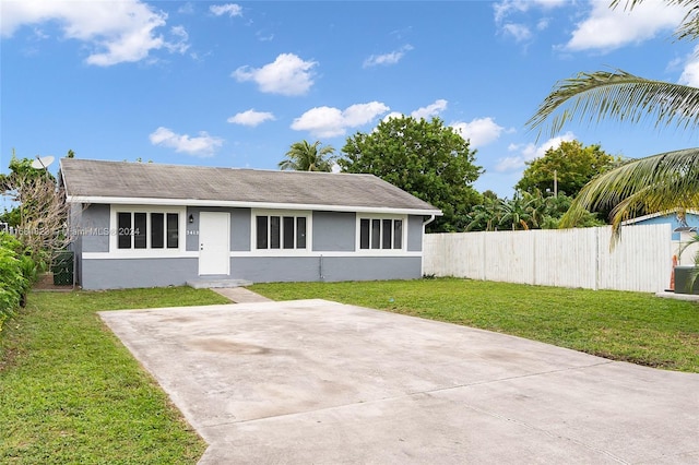 rear view of property featuring a lawn