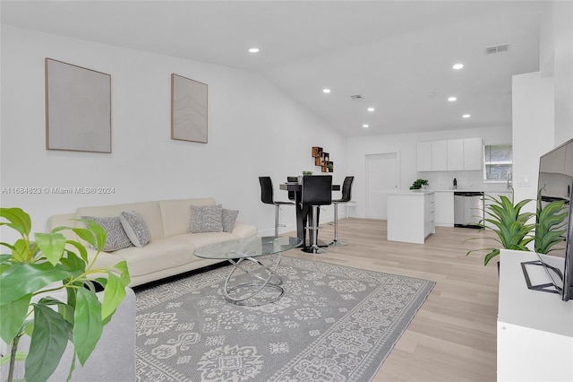 living room featuring recessed lighting, visible vents, light wood finished floors, and lofted ceiling