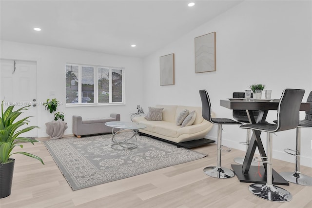 living room with baseboards, vaulted ceiling, recessed lighting, and wood finished floors
