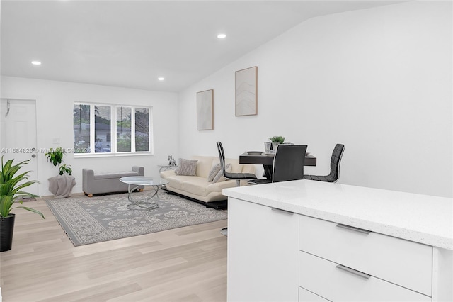 living area with recessed lighting, vaulted ceiling, and light wood-style floors