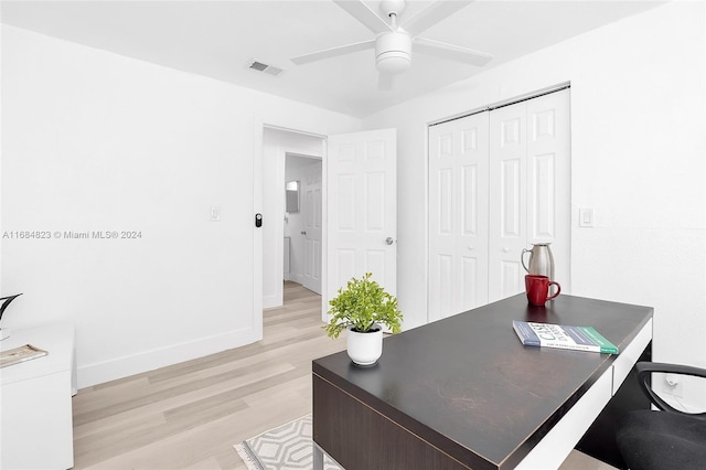 office area with baseboards, ceiling fan, light wood-type flooring, and visible vents