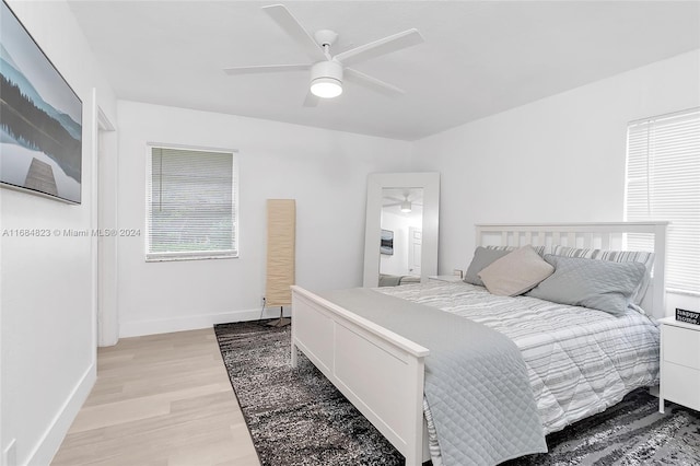 bedroom with light hardwood / wood-style flooring and ceiling fan