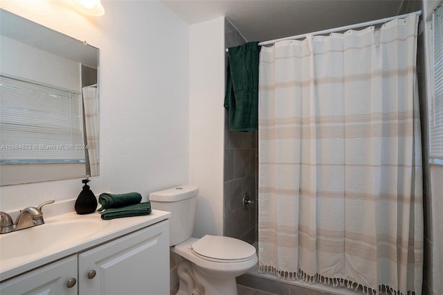 bathroom featuring vanity, a shower with shower curtain, toilet, and tile patterned flooring