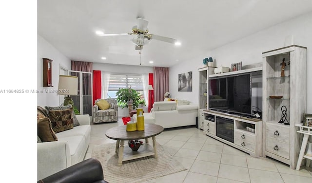 living room featuring light tile patterned floors and ceiling fan