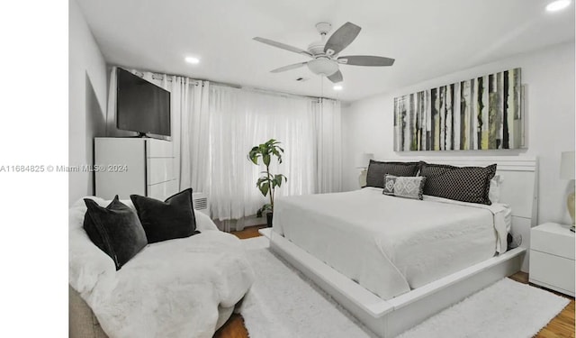 bedroom featuring hardwood / wood-style floors and ceiling fan