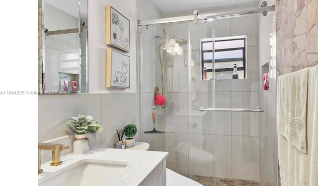 bathroom featuring vanity, decorative backsplash, a shower with shower door, and toilet