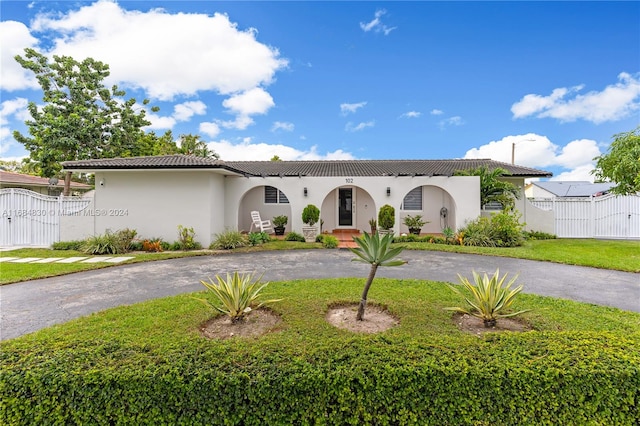 mediterranean / spanish-style home with a front yard