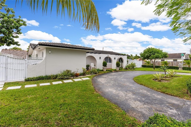 mediterranean / spanish-style house featuring a front lawn