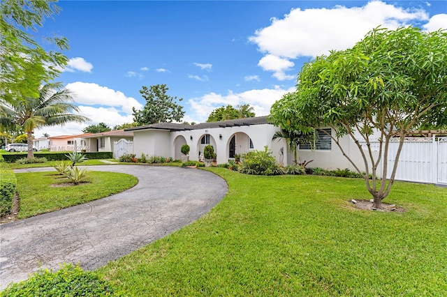 mediterranean / spanish home featuring a front yard