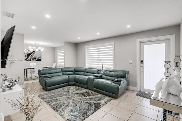 tiled living room featuring an inviting chandelier