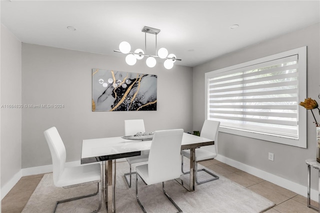 tiled dining room featuring a chandelier