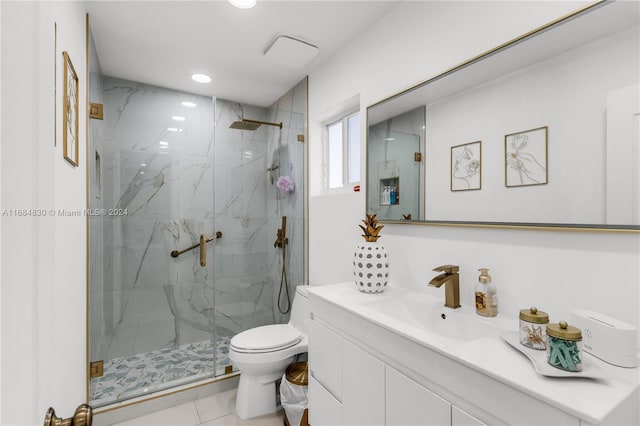 bathroom with vanity, tile patterned floors, toilet, and an enclosed shower