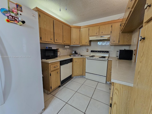 kitchen with white appliances, tasteful backsplash, sink, a textured ceiling, and light tile patterned floors