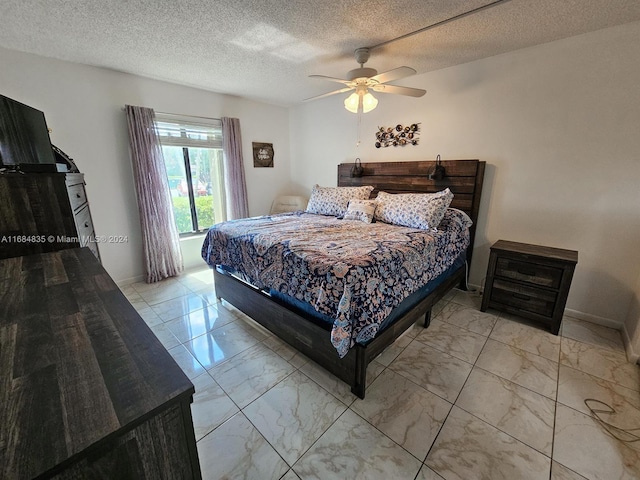 814 Sky Pine Way Unit C1, Green Acres, FL 33415 - bedroom with marble finish floors, a ceiling fan, a textured ceiling, and baseboards
