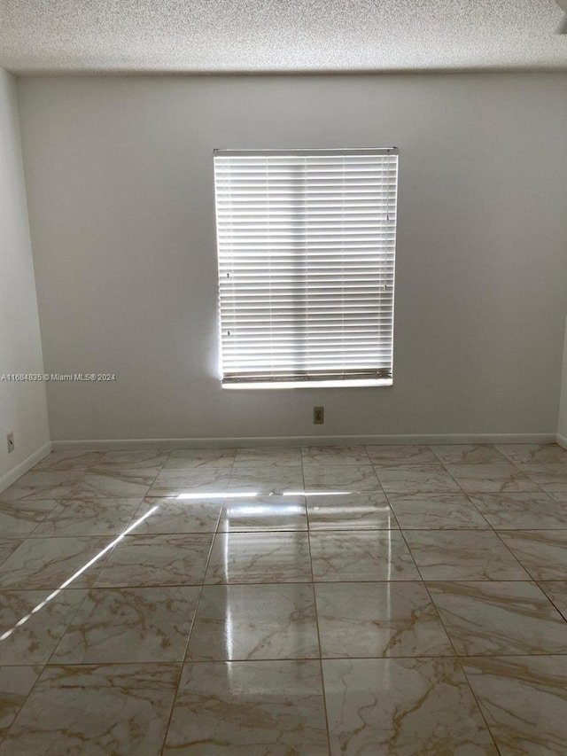 empty room with a textured ceiling