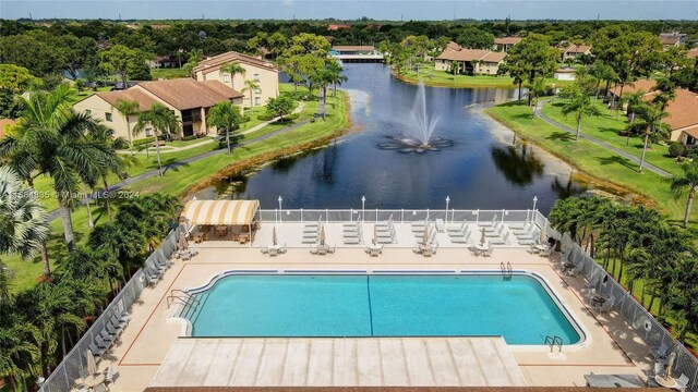 814 Sky Pine Way Unit C1, Green Acres, FL 33415 - community pool with a water view and fence