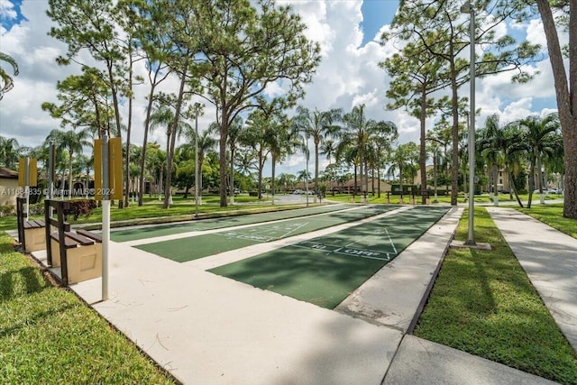 814 Sky Pine Way Unit C1, Green Acres, FL 33415 - view of community with shuffleboard, uncovered parking, and a yard