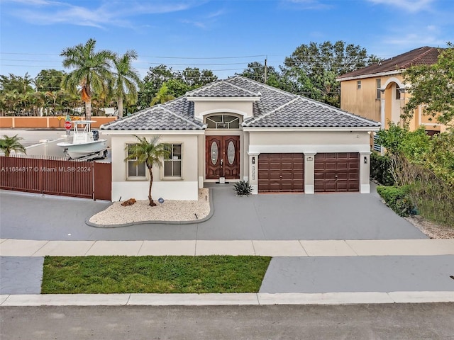 mediterranean / spanish-style house with a garage