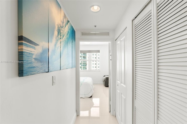 hall featuring light tile patterned floors