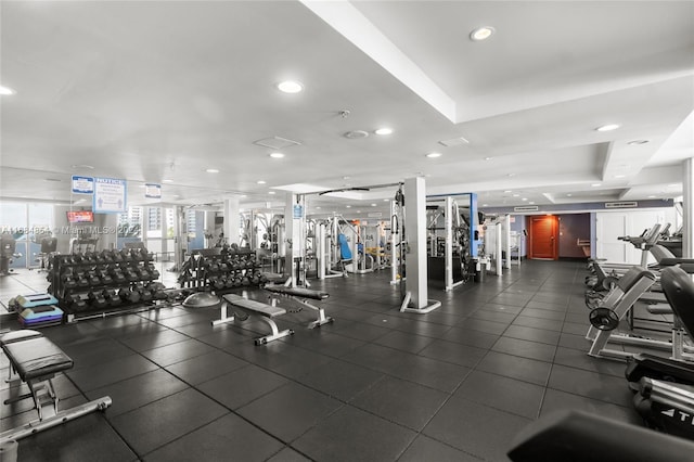 exercise room featuring a raised ceiling