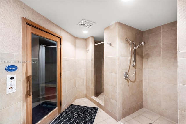 bathroom featuring tile walls, curtained shower, and tile patterned flooring