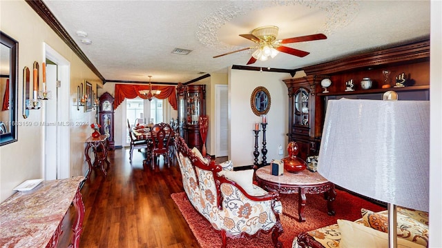 interior space with ceiling fan, a textured ceiling, dark hardwood / wood-style flooring, and crown molding