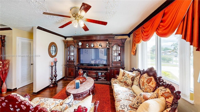 living room featuring a textured ceiling, ceiling fan, ornamental molding, and dark hardwood / wood-style floors