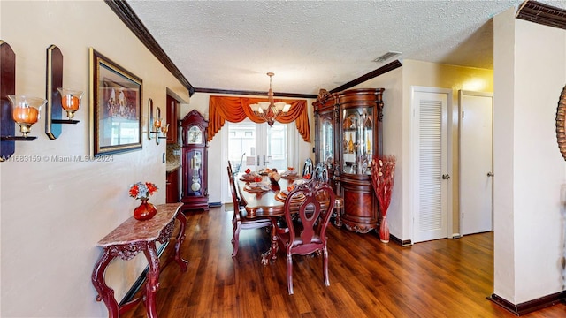 dining area with crown molding, dark wood-type flooring, an inviting chandelier, and a textured ceiling