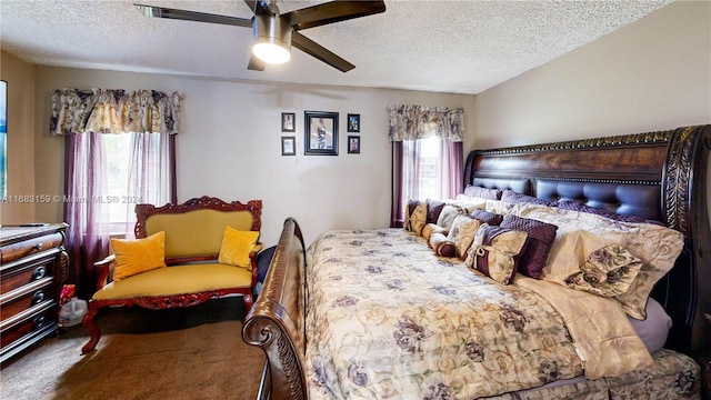 bedroom featuring ceiling fan, a textured ceiling, and carpet