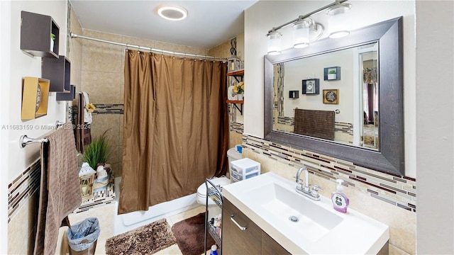 full bathroom with toilet, shower / bath combo, tasteful backsplash, and vanity