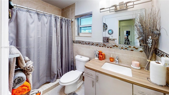 bathroom featuring tile patterned floors, vanity, tile walls, toilet, and a shower with shower curtain