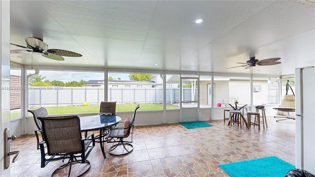 sunroom featuring ceiling fan