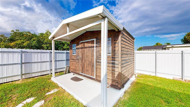 view of outbuilding with a yard