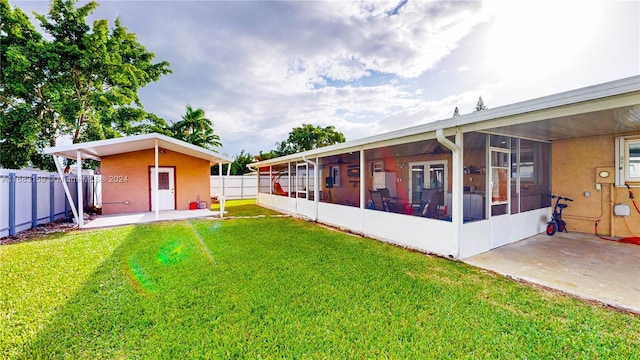 view of yard featuring a patio area and a sunroom