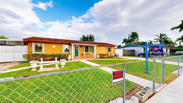 ranch-style home featuring a front yard