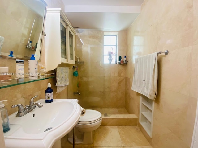 bathroom featuring sink, a shower with shower door, toilet, tile walls, and tile patterned flooring