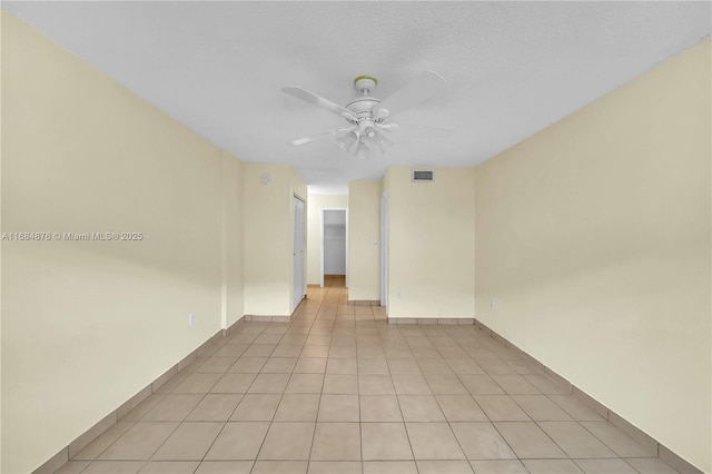 unfurnished room featuring a textured ceiling and ceiling fan