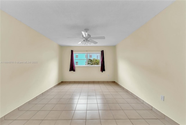 unfurnished room with light tile patterned floors and ceiling fan