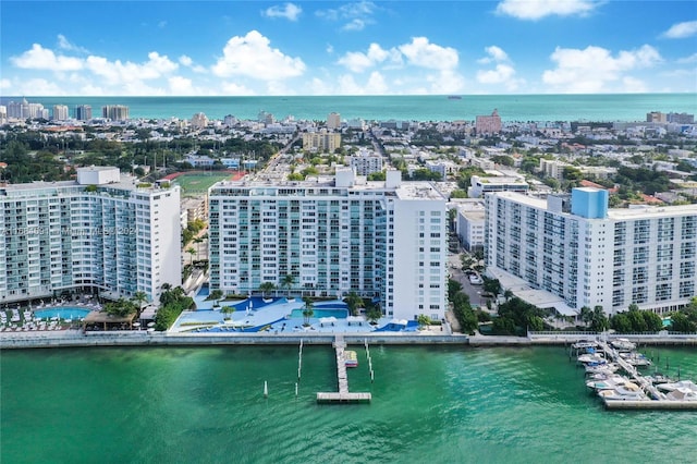 birds eye view of property with a view of city and a water view