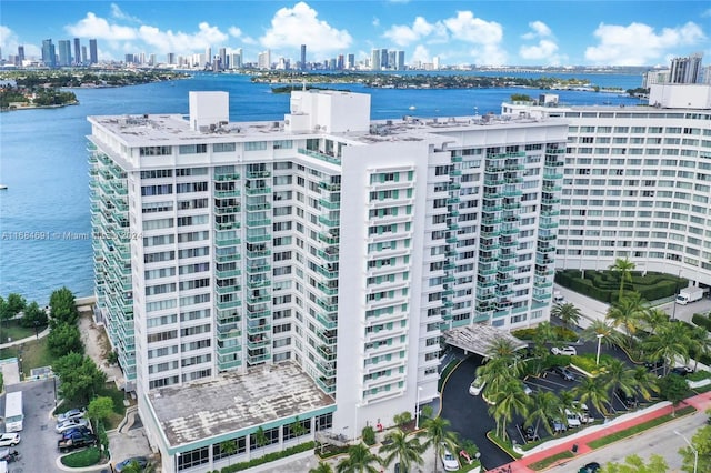 drone / aerial view featuring a city view and a water view