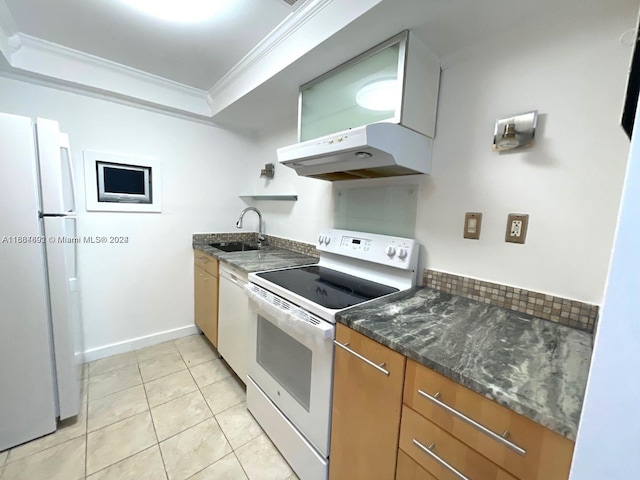 kitchen featuring light tile patterned floors, dark stone countertops, crown molding, sink, and white appliances