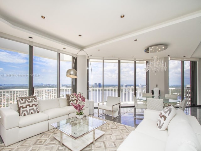 living room featuring a wealth of natural light, hardwood / wood-style flooring, and a wall of windows