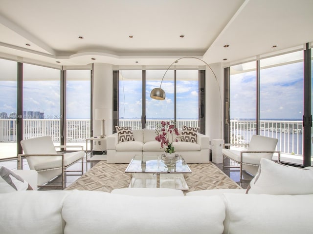 living room with a water view and expansive windows