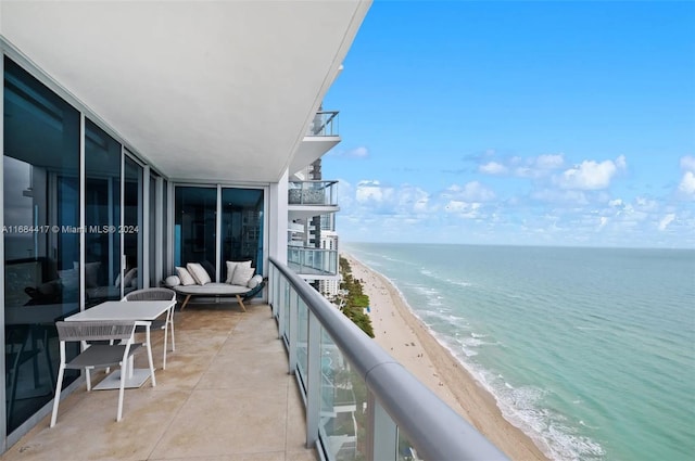 balcony with a water view and a beach view