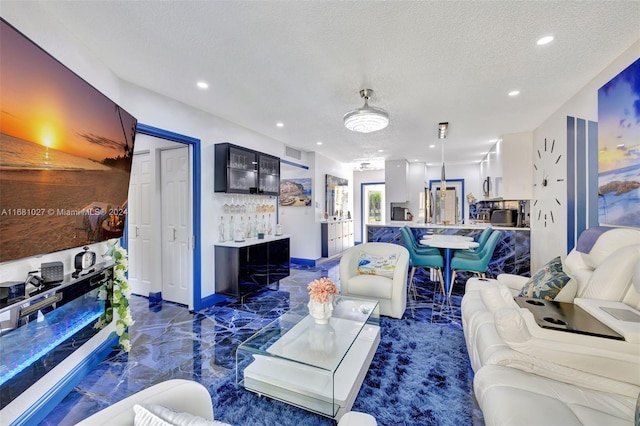 living room with bar and a textured ceiling