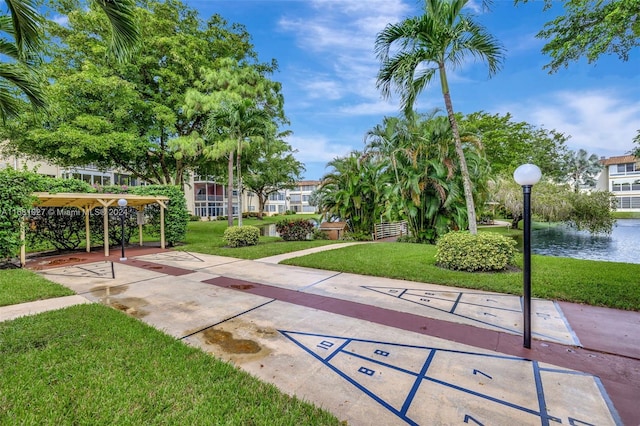 view of community featuring a yard and a water view